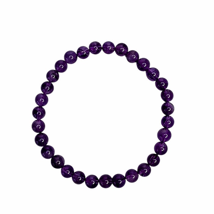A beaded stretch bracelet made of polished, round purple gemstone beads, arranged in a circular shape against a solid white background.