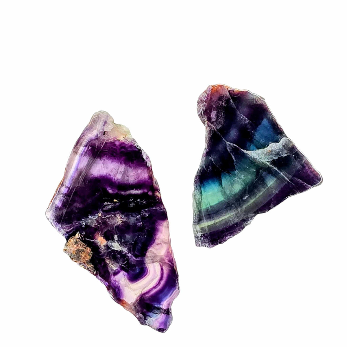Two fluorite slab pieces with purple centers and blue-green banding