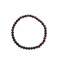 A beaded stretch bracelet made of glossy, dark red and black round beads, arranged in a circular shape on a plain white background.