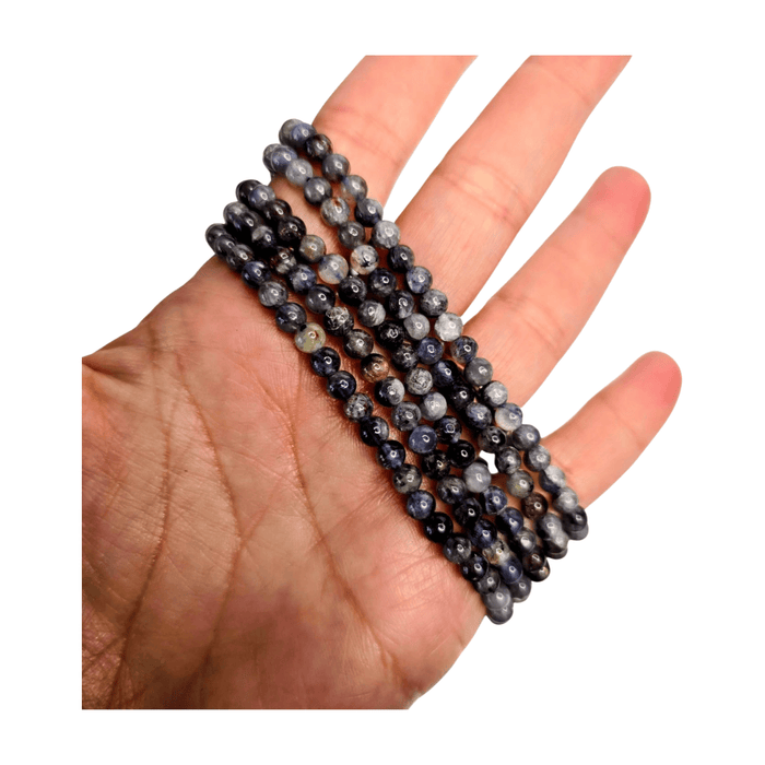 Iolite bead bracelet on hand, layered round beads with blue-gray tones