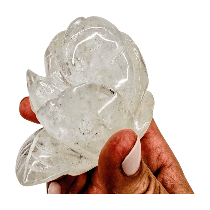 Rose quartz rose lamp, close-up of clear translucent petals held by hand