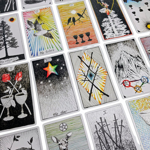 Assorted tarot cards fanned in a grid, colorful illustrated faces